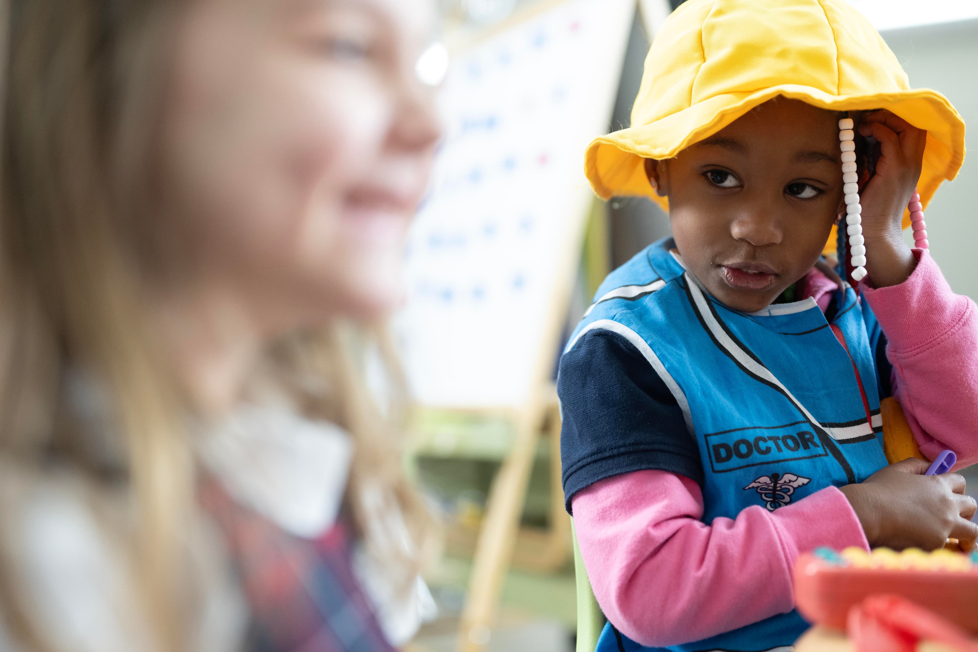 prekindergarten children playing dress up