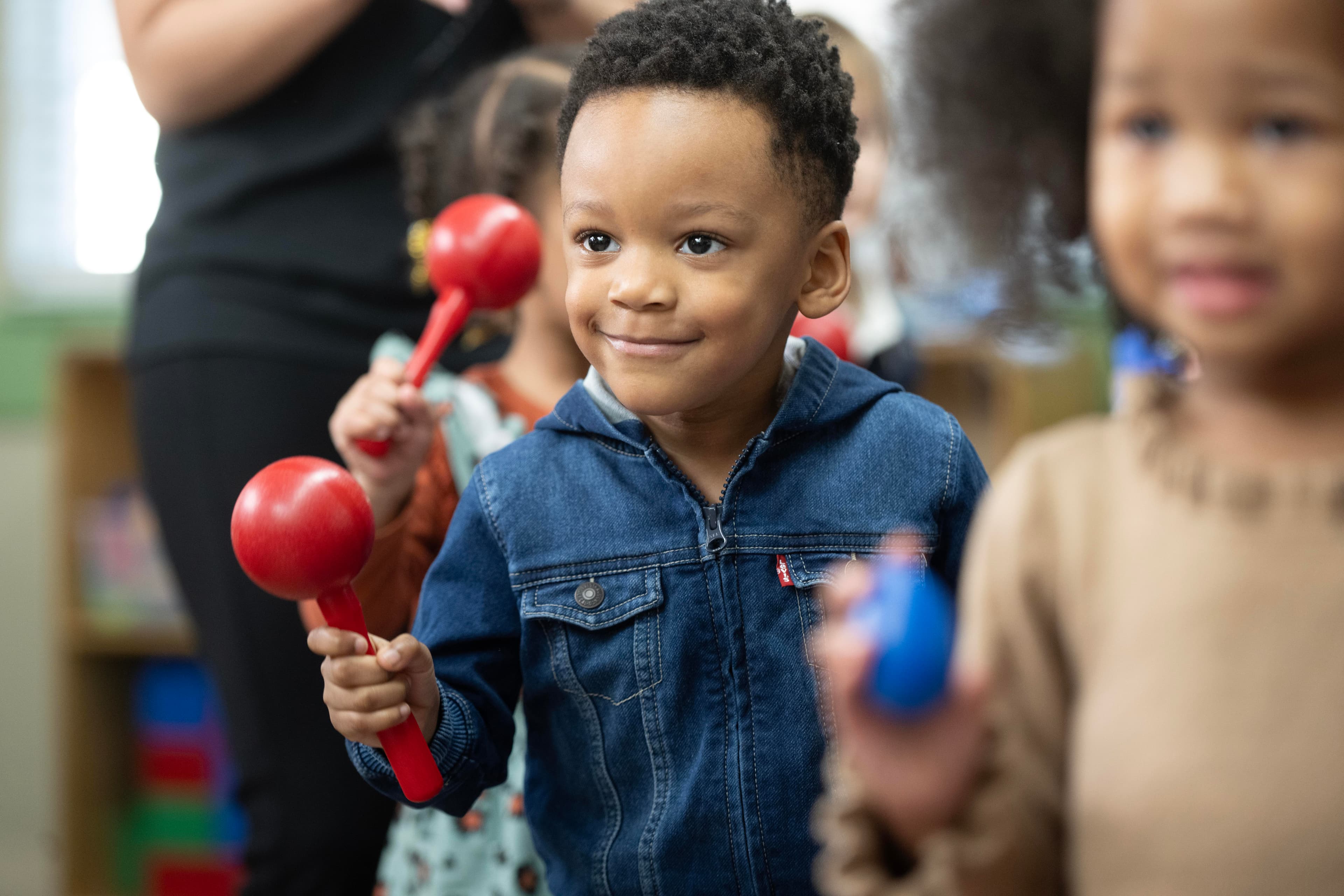 preschool child shaking a maraca