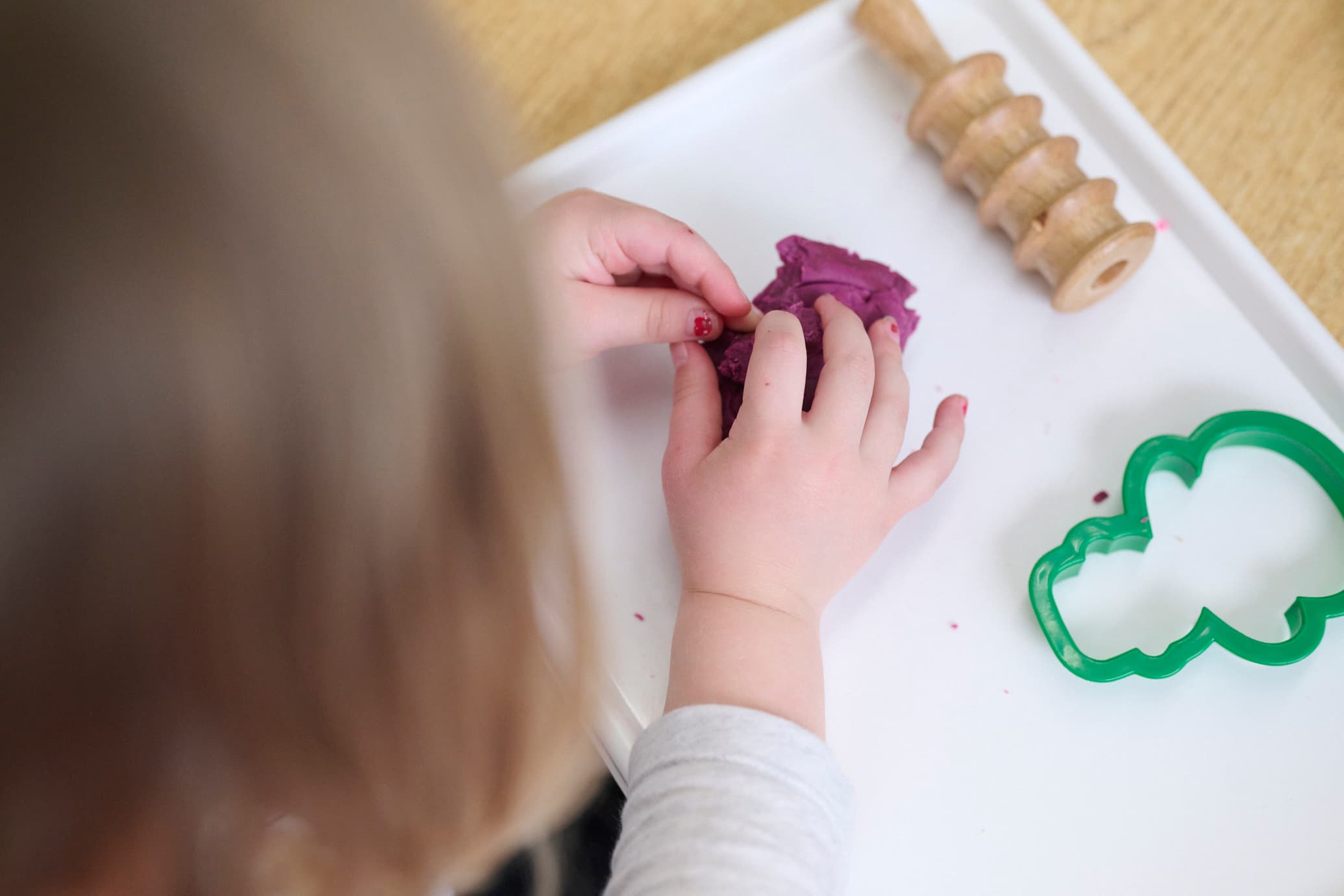 child playing with playdough